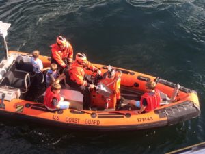 A smallboat crew from the Coast Guard Cutter Sea Fox an 87-foor patrol boat home ported in Bangor, Wash., removes four children from the 32-foot pleasure craft Kloshi Bay which was reported on fire near Point Wilson, Wash. July 27, 2015. The children were then transferred to the Jefferson County Fire Boat Guardian for further transport to Port Townsend. U.S. Coast Guard photo courtesy of the Coast Guard Cutter Sea Fox.